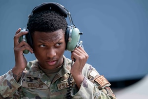 An Airman adjusts his headset.