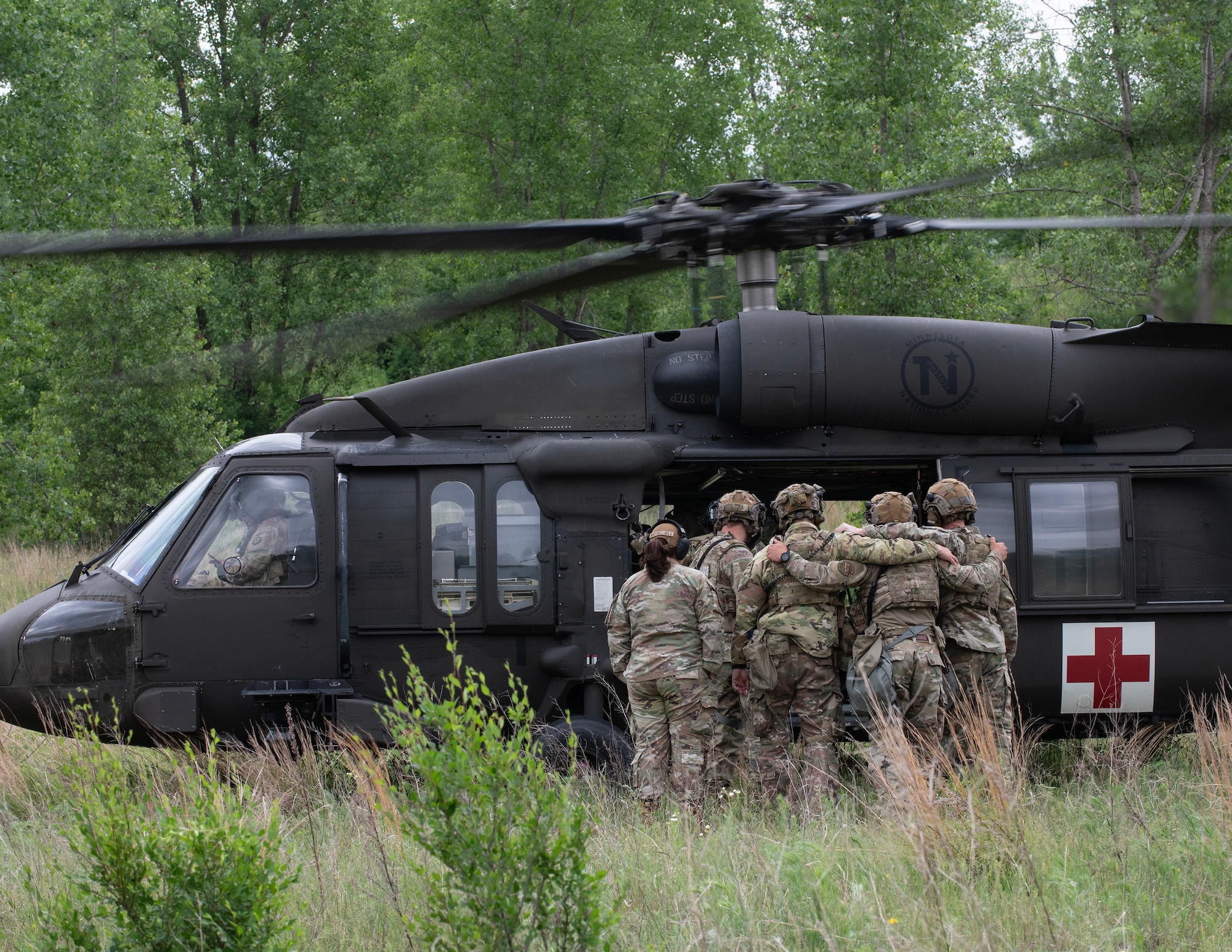 U.S. Air Force Airmen from the 133rd Security Force Squadron load simulate patients onto a UH-60 Black Hawk helicopter from the Charlie Company, 2nd Battalion, 211th Aviation Regiment, 34th Combat Aviation Brigade, Minnesota National Guard, in Arden Hills, Minn., June 11, 2026.