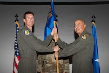 Brig. Gen. David Epperson passes the unit guidon to Col. Hector Ortega