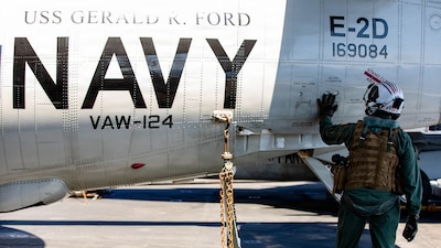 Rear Adm. Paul Lanzilotta, Commander, Carrier Strike Group 12, conducts preflight checks on an E-2D Hawkeye, assigned to Airborne Command and Control Squadron 124, on the flight deck of the world’s largest aircraft carrier, USS Gerald R. Ford (CVN 78), while underway in the Mediterranean Sea, April 12, 2026. Gerald R. Ford is on a scheduled deployment in the U.S. 6th Fleet area of operations to support the warfighting effectiveness, lethality and readiness of U.S. Naval Forces Europe-Africa, and defend U.S., Allied and partner interests in the region. (U.S. Navy photo by Mass Communication Specialist 2nd Class Mariano Lopez)