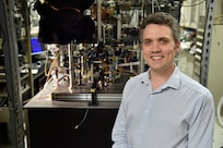 Adam Black, Ph.D., director of the U.S. Naval Research Laboratory’s Quantum Science Institute, stands in front of a quantum research experiment at NRL. The institute coordinates quantum research across the laboratory to advance technologies supporting future Navy capabilities.  (U.S. Navy photo by Jonathan Steffen)