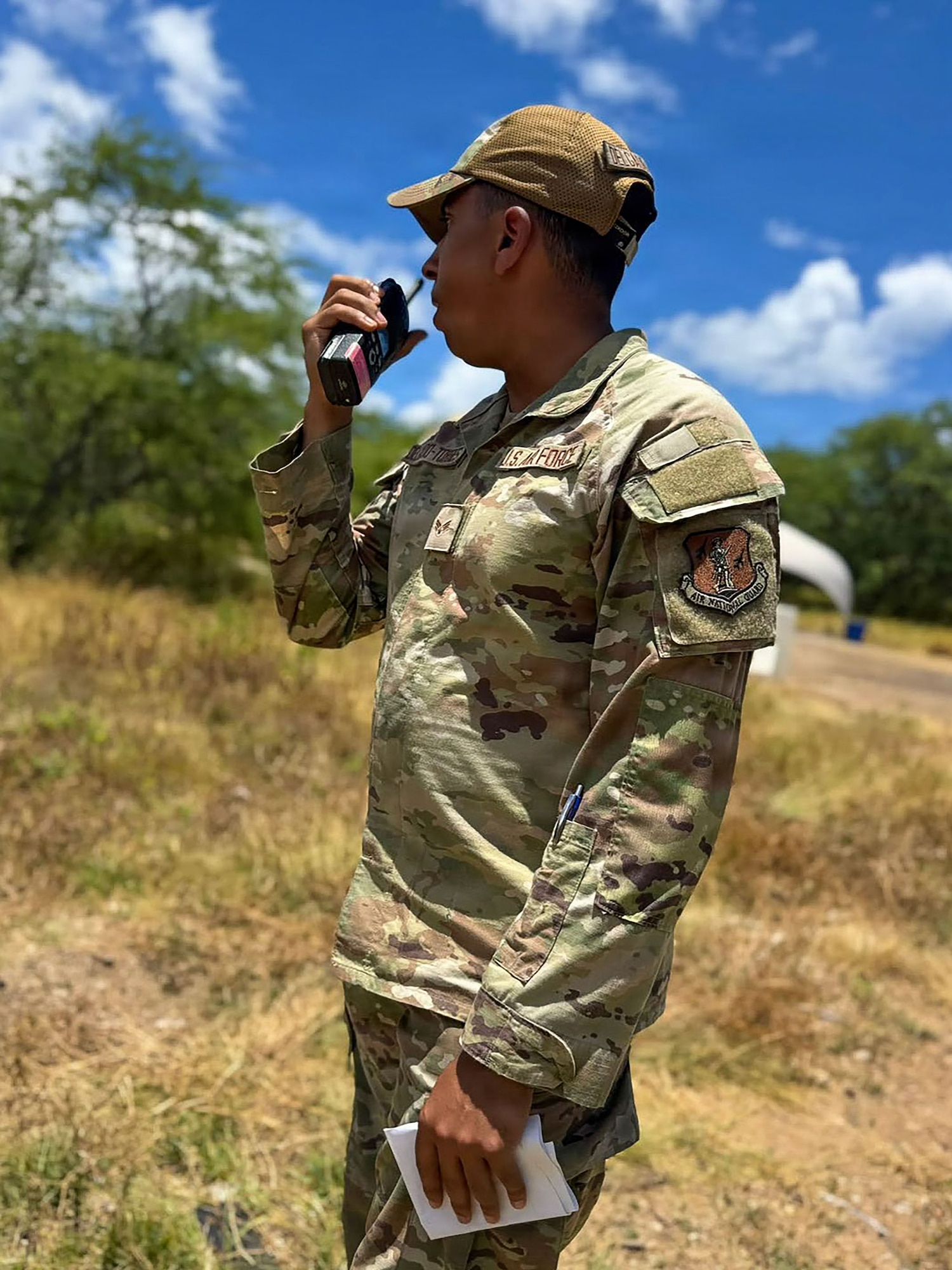 U.S. Air Force Senior Airman Kieann Delgado, sustainment services journeyman, 156th Force Support Squadron, Puerto Rico Air National Guard, speaks via radio during the fiscal year 2026 Home Station Readiness Training at Joint Base Pearl Harbor-Hickam, Hawaii, June 22, 2026. The FY26 HSRT is a Joint total force integration training involving the 140th FSS, 154th FSS, 142nd FSS, 936th FSS, and 156th FSS, designed to test participants expeditionary capabilities and ensure that force support personnel are prepared to perform their mission in a contested environment. (U.S. Air National Guard courtesy photo)