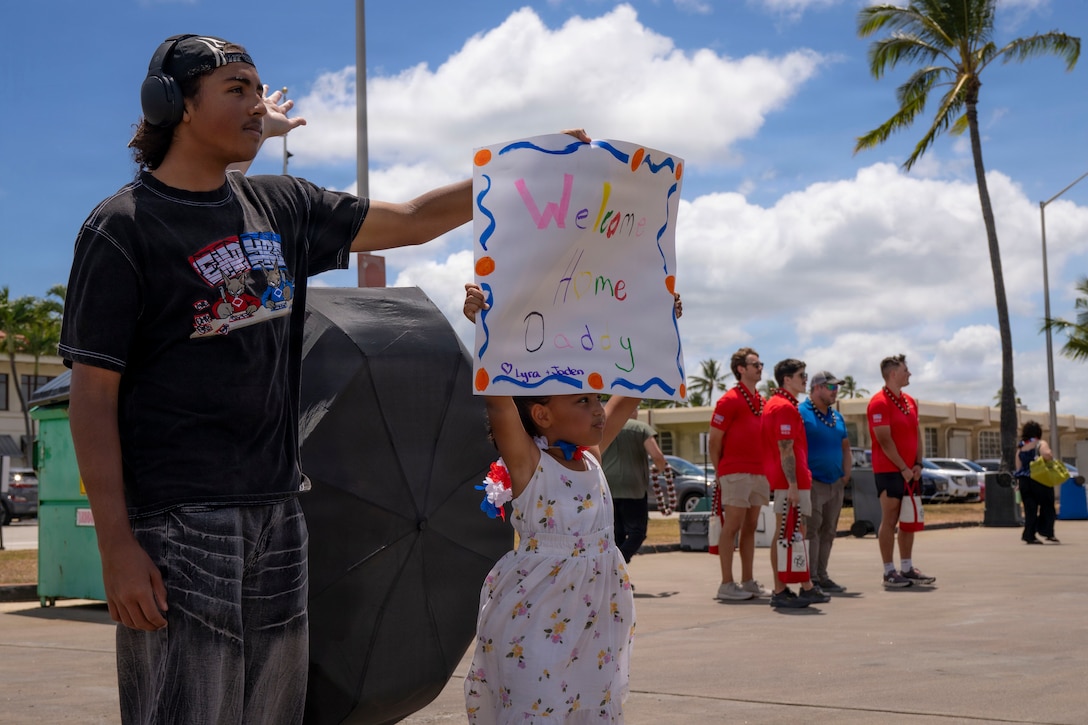 Families greet USCGC Midgett (WMSL 757) as it returns to home port at Coast Guard Base Honolulu, July 20, 2026. The cutter returned from a five-month deployment in the Western Pacific. (U.S. Coast Guard photo by Petty Officer 2nd Class Mikaela McGee)