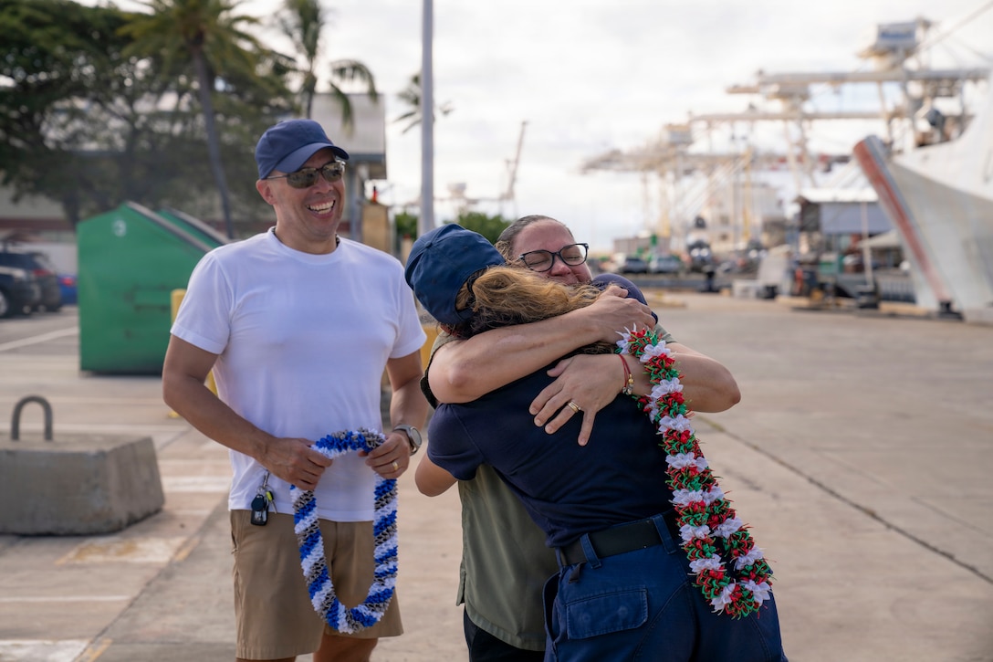 USCGC Midgett (WMSL 757) returns to its home port and crew members greet their families waiting at the pier at USCG Base Honolulu, July 20, 2026. Families of the crew waited to greet their loved ones after the cutter returned from a five-month patrol in the Western Pacific. (U.S. Coast Guard photo by Petty Officer 2nd Class Mikaela McGee)