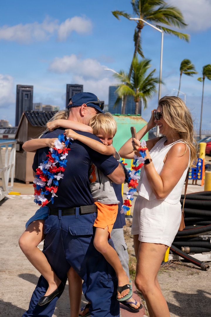 USCGC Midgett (WMSL 757) crew members greet their families at USCG Base Honolulu, July 20, 2026. Families of the crew waited to greet their loved ones after the cutter returned from a five-month patrol in the Western Pacific. (U.S. Coast Guard photo by Petty Officer 2nd Class Mikaela McGee)