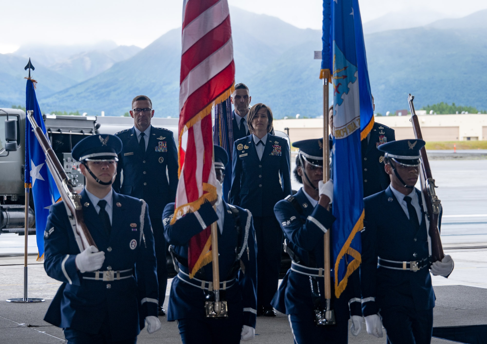 U.S. Air Force Lt. Gen. Robert Davis, commander of the Alaskan NORAD Region, Alaskan Command and Eleventh Air Force, left, and U.S. Air Force Col. Lisa Mabbutt, outgoing 673d Air Base Wing commander, center, stand at attention during the presentation of the colors during the 673d Air Base Wing change of command ceremony on Joint Base Elmendorf-Richardson, Alaska, July 22, 2026.