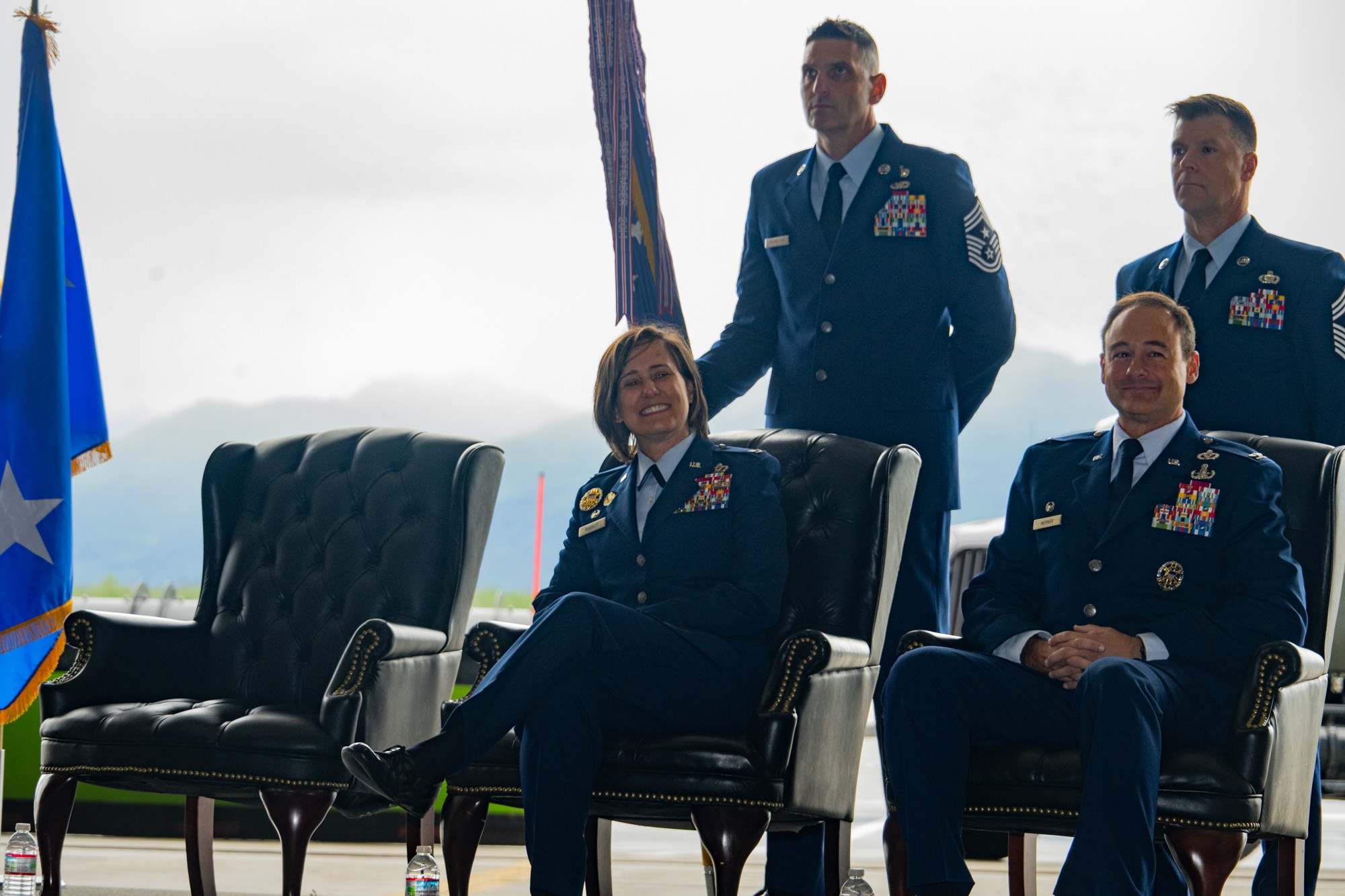 U.S. Air Force Col. Lisa Mabbutt, outgoing Joint Base Elmendorf Richardson 673rd Air Base Wing commander, is joined onstage by U.S. Air Force Col. Daniel Werner, 673d ABW commander, front right, Chief Master Sgt. Michael Sylvester, outgoing wing command chief, and Chief Master Sgt. Edward Mueller, incoming wing command chief, during a change-of-command ceremony on JBER, Alaska, July 22, 2026.