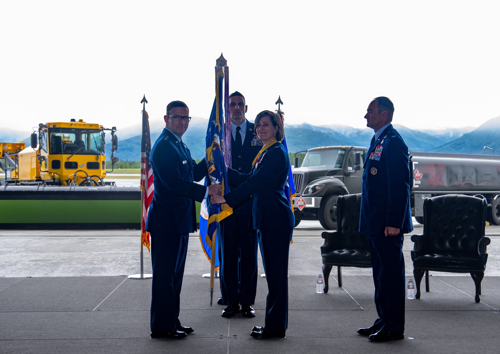 U.S. Air Force Lt. Gen. Robert Davis, commander of the Alaskan NORAD Region, Alaskan Command and Eleventh Air Force, left, receives the 673d Air Base Wing guidon from Col. Lisa Mabbutt, outgoing 673d ABW commander, during a change-of-command ceremony on Joint Base Elmendorf-Richardson, Alaska, July 22, 2026.