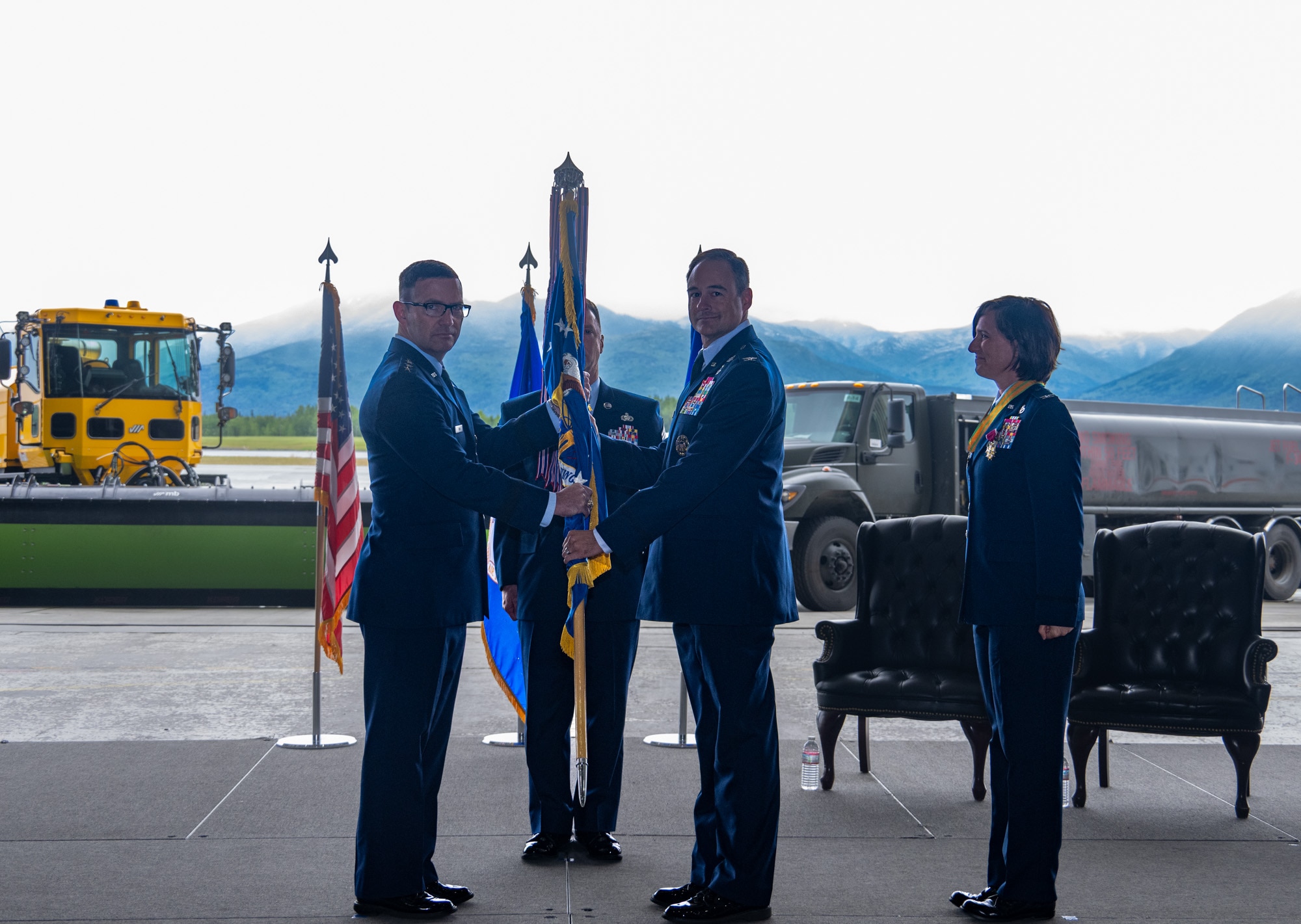 U.S. Air Force Lt. Gen. Robert Davis, commander of the Alaskan NORAD Region, Alaskan Command and Eleventh Air Force, left, presents the 673d Air Base Wing guidon to U.S. Air Force Col. Daniel Werner, incoming 673d ABW commander, during a change-of-command ceremony on Joint Base Elmendorf-Richardson, Alaska, July 22, 2026.