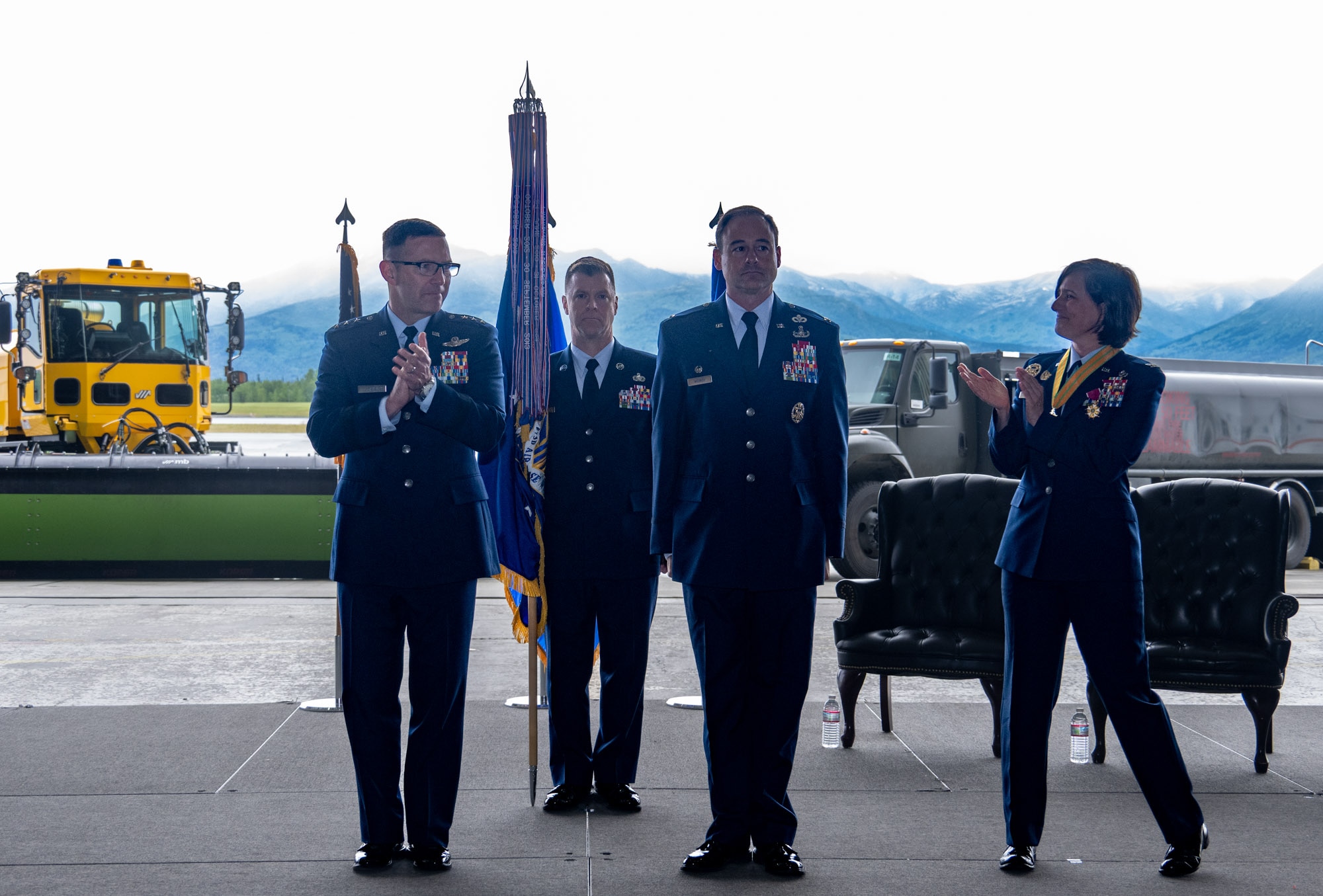 U.S. Air Force Lt. Gen. Robert Davis, commander of the Alaskan NORAD Region, Alaskan Command and Eleventh Air Force, left, joins U.S. Air Force Col. Lisa Mabbutt, outgoing 673d Air Base Wing commander, right, in congratulating Col. Daniel Werner in the moments after he officially assumed command of the 673 ABW during a change-of-command ceremony on Joint Base Elmendorf-Richardson, Alaska, July 22, 2026.