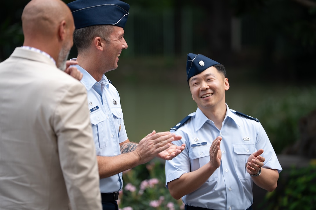 U.S. Air Force Lt. Col. Jee Chung, right, incoming Defense POW/MIA Accounting Agency Detachment 1 leader, and U.S. Air Force Lt. Col. Aaron Thomas, center, outgoing Detachment 1 leader, applaud each other at the conclusion of a change of leadership ceremony at the U.S. Embassy in Bangkok, July 15, 2026.