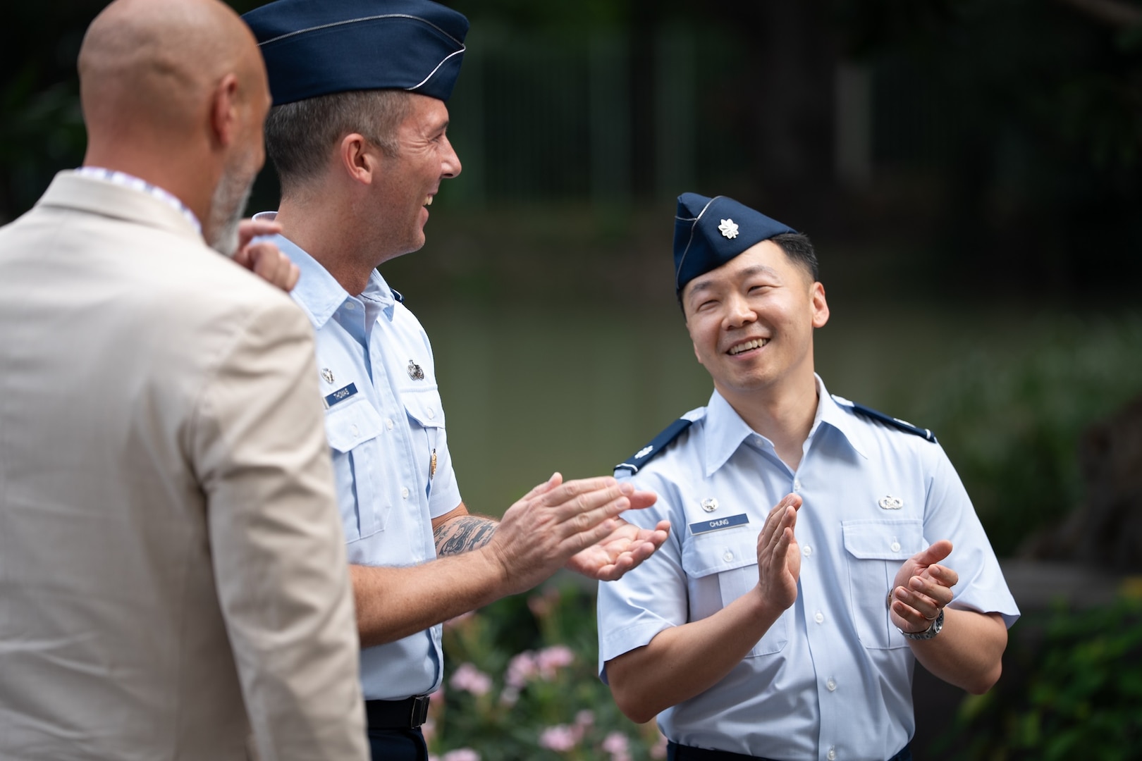 U.S. Air Force Lt. Col. Jee Chung, right, incoming Defense POW/MIA Accounting Agency Detachment 1 leader, and U.S. Air Force Lt. Col. Aaron Thomas, center, outgoing Detachment 1 leader, applaud each other at the conclusion of a change of leadership ceremony at the U.S. Embassy in Bangkok, July 15, 2026.