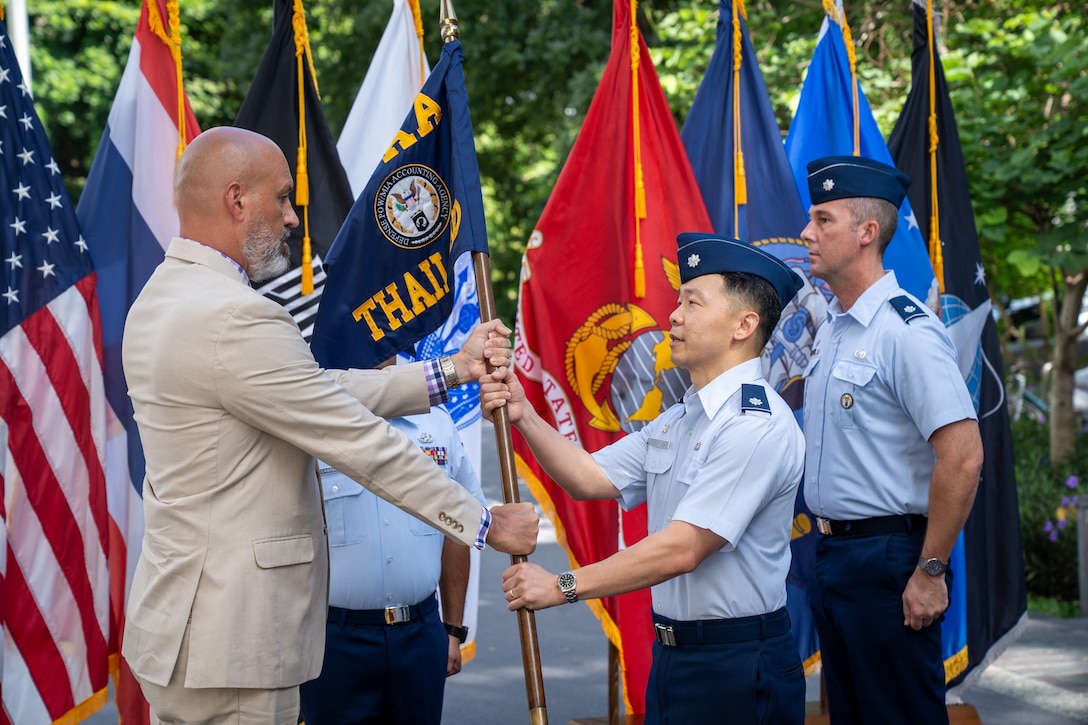 U.S. Air Force Lt. Col. Jee Chung, incoming Defense POW/MIA Accounting Agency Detachment 1 leader, assumes authority from Christopher Phelps, DPAA Indo-Pacific director, during a Detachment 1 change of leadership ceremony at the U.S. Embassy in Bangkok, July 15, 2026.