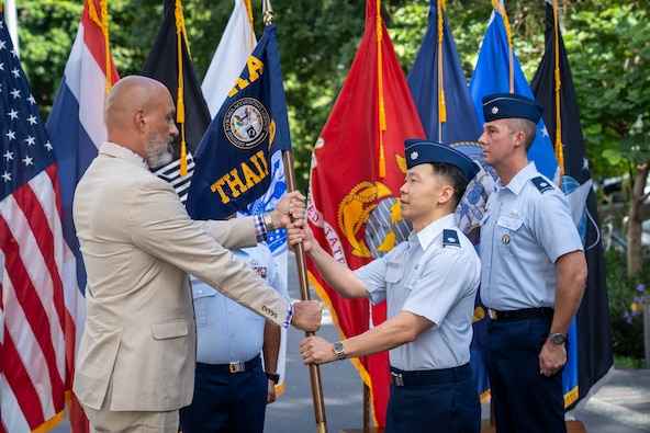 U.S. Air Force Lt. Col. Jee Chung, incoming Defense POW/MIA Accounting Agency Detachment 1 leader, assumes authority from Christopher Phelps, DPAA Indo-Pacific director, during a Detachment 1 change of leadership ceremony at the U.S. Embassy in Bangkok, July 15, 2026.