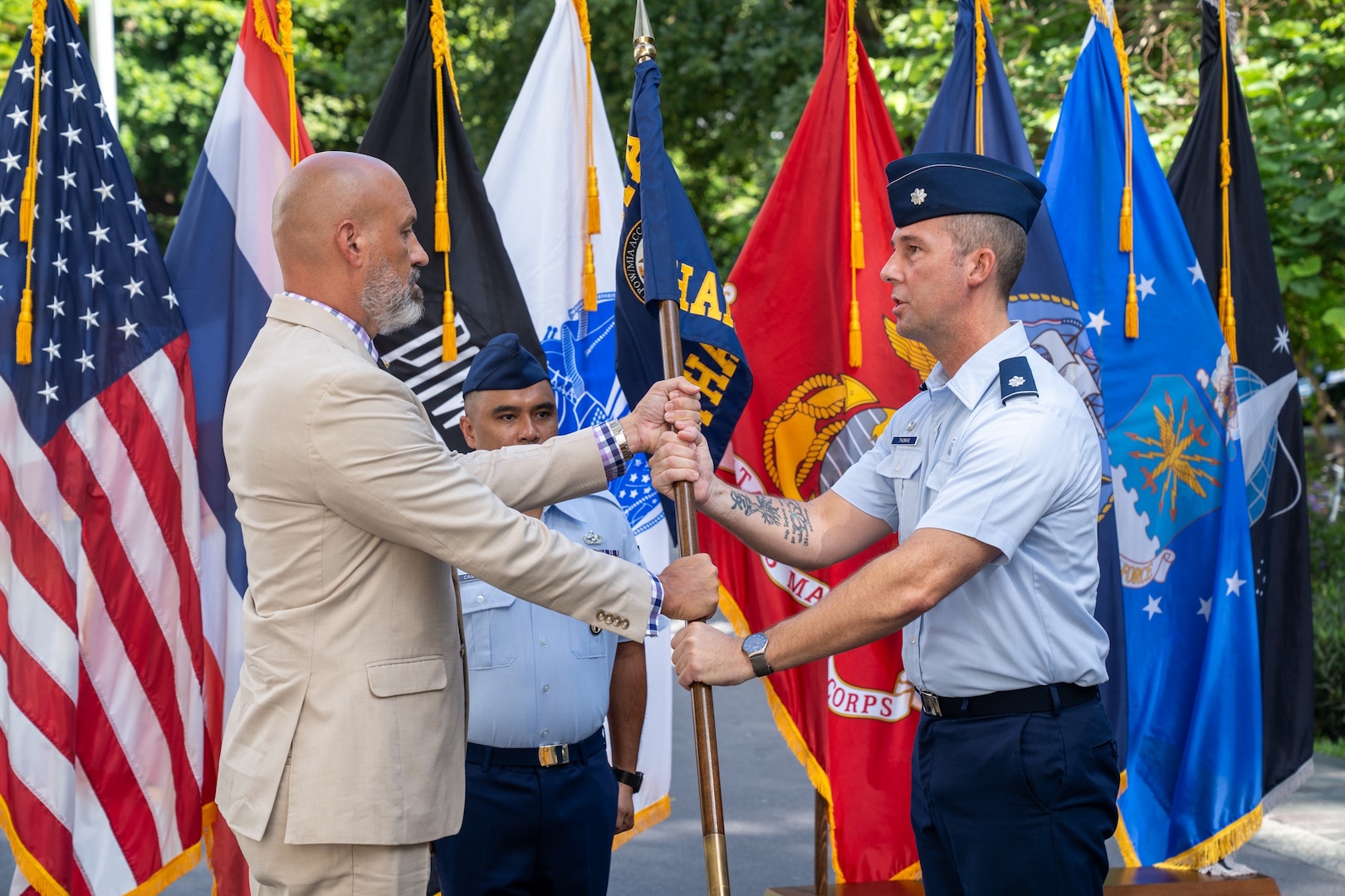 U.S. Air Force Lt. Col. Aaron Thomas, outgoing Defense POW/MIA Accounting Agency Detachment 1 leader, relinquishes authority to Christopher Phelps, DPAA Indo-Pacific director, during a change of leadership ceremony at the U.S. Embassy in Bangkok, July 15, 2026.