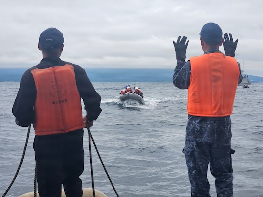 U.S. Navy Sailors from Avenger-class mine countermeasures ship USS Chief (MCM 14) drive a rigid-hull inflatable boat towards the Japan Maritime Self-Defense Force ocean mine sweeper JS Awaji (MSO-304) during Mine Warfare Exercise 2JA, July 20, 2026. 2JA is part of a year-long series of bilateral exercises between the U.S. Navy and JMSDF to strengthen interoperability and increase proficiency in mine countermeasure operations. (U.S. Navy photo by Lt. Jacob Kinnear)