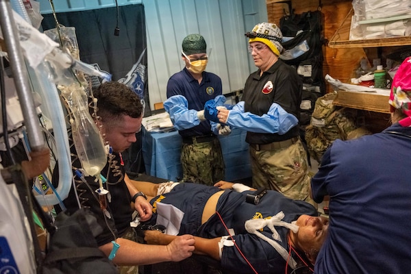 Pacific Friendship 2026 (PF26) and Pacific Partnership 2026 (PP26) medical personnel prepare a simulated casualty for surgery in an operating suite inside a container express (CONEX) box as part of a PF26-led mass casualty (MASCAL) drill aboard U.S. Army Runnymede-class landing craft utility ship USAV Paulus Hook (LCU 2033) at Hon La Port in Quang Tri, Vietnam, July 2, 2026.