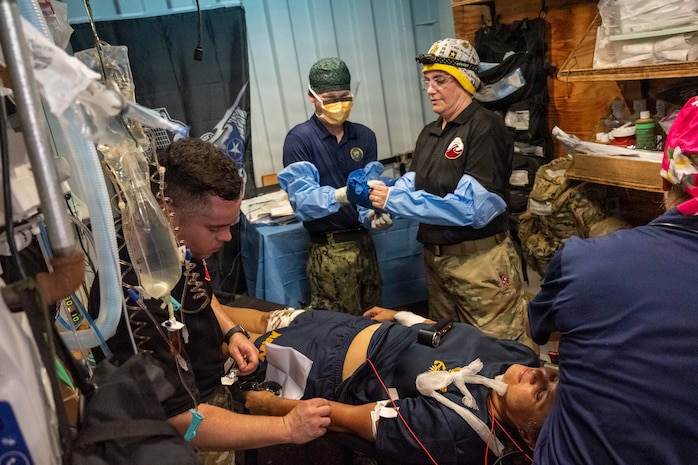 Pacific Friendship 2026 (PF26) and Pacific Partnership 2026 (PP26) medical personnel prepare a simulated casualty for surgery in an operating suite inside a container express (CONEX) box as part of a PF26-led mass casualty (MASCAL) drill aboard U.S. Army Runnymede-class landing craft utility ship USAV Paulus Hook (LCU 2033) at Hon La Port in Quang Tri, Vietnam, July 2, 2026.