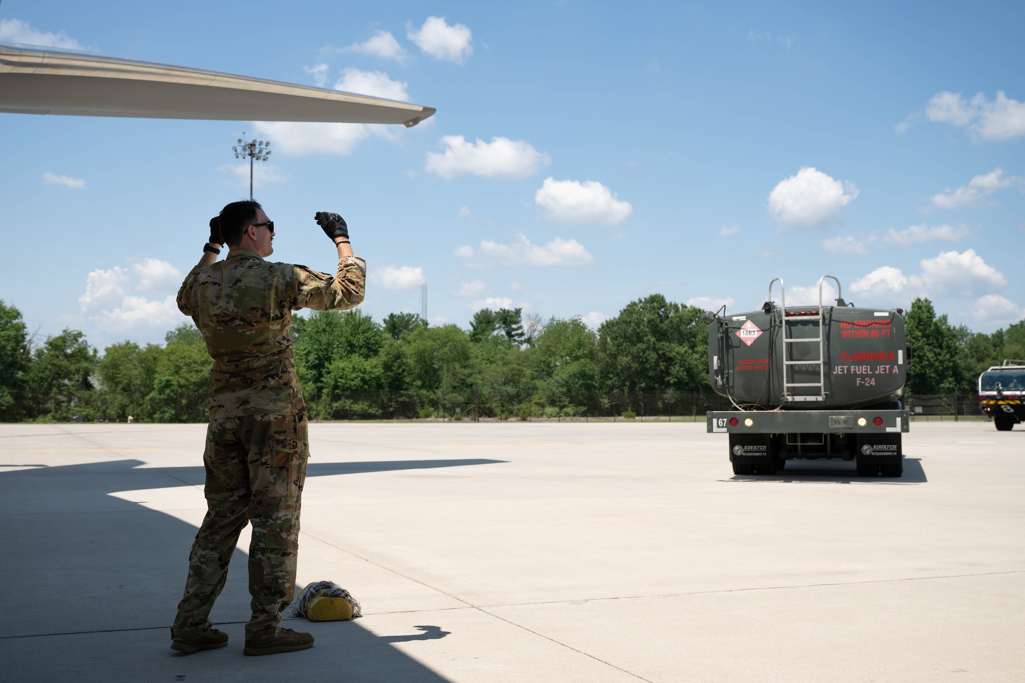 U.S. Air Force Senior Airman Brandon Rivas, 32nd Air Refueling Squadron instructor boom operator, guides a fuel truck toward a KC-46A Pegasus, Aircraft in preparation for specialized fueling operations at Joint Base McGuire-Dix-Lakehurst, N.J., June 29, 2026.