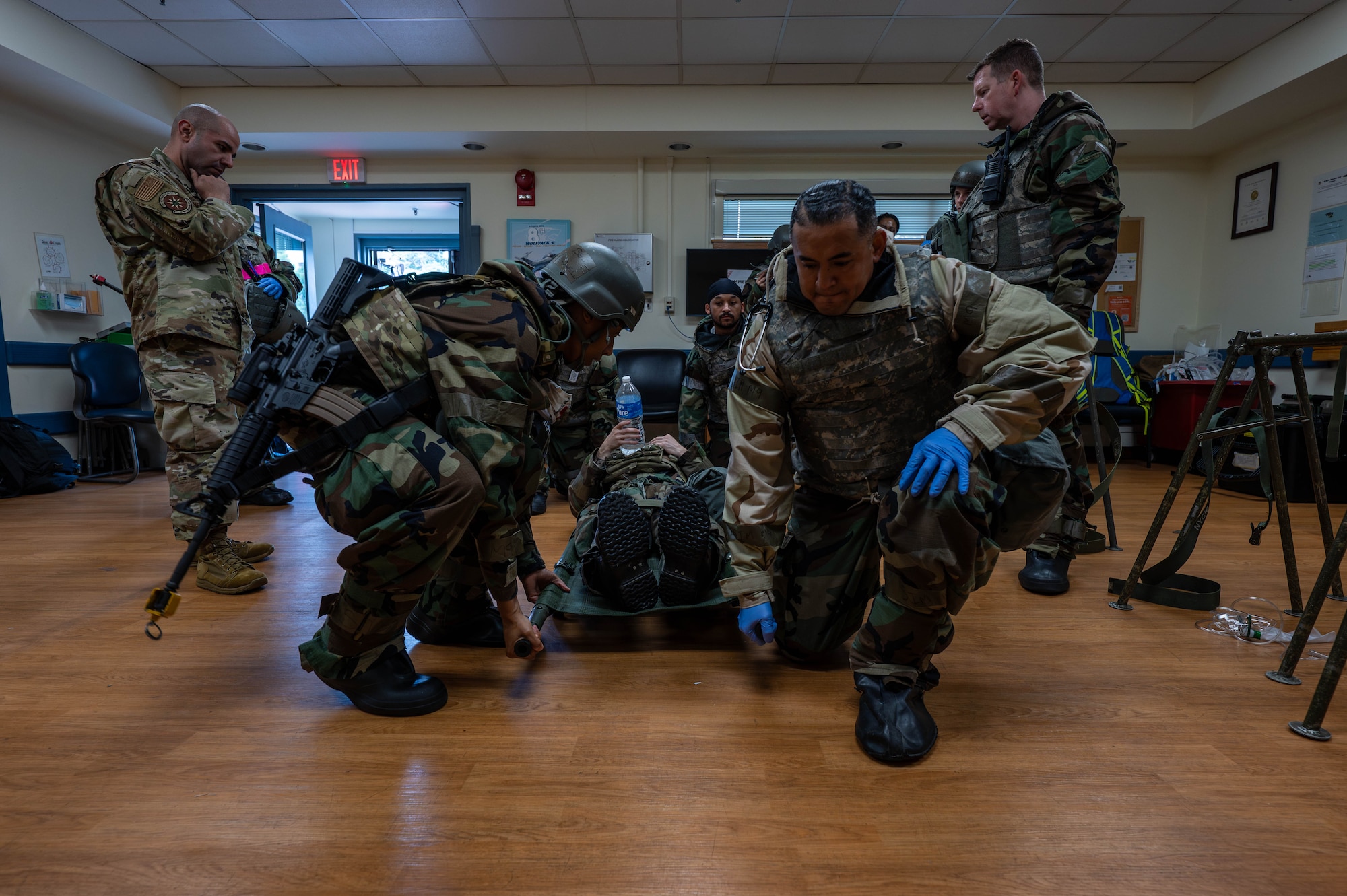 U.S. Air Force Airmen assigned to the 8th Medical Group prepare to move a simulated casualty for further care during exercise Beverly Sentinel 26-4, at Kunsan Air Base, Republic of Korea, July 23, 2026. The realistic training environment of Bev. Sent. 26-4 required personnel to adapt and overcome complex challenges, ensuring they are fully equipped to execute the mission under high-stress conditions. (U.S. Air Force photo by Staff Sgt. Cedrique Oldaker)