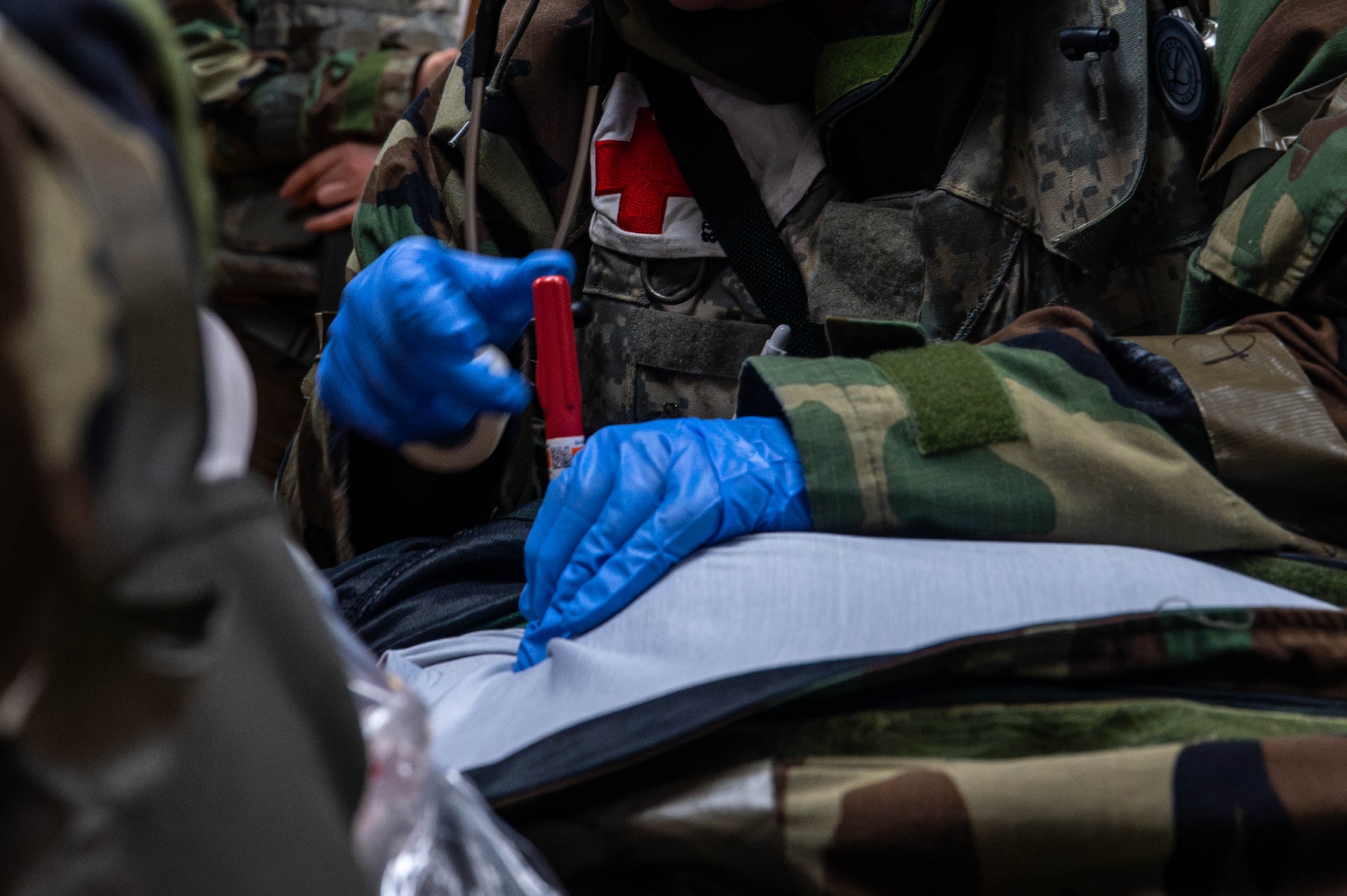 A U.S. Air Force Airman assigned to the 8th Medical Group simulates conducting a needle decompression on a simulated casualty during exercise Beverly Sentinel 26-4, at Kunsan Air Base, Republic of Korea, July 23, 2026. Every Airman assigned to the 8th Fighter Wing from security forces to maintenance, utilizes exercises such as Bev. Sent. 26-4 to hone technical skills and build the combat-credible mindset required for the modern battlefield. (U.S. Air Force photo by Staff Sgt. Cedrique Oldaker)