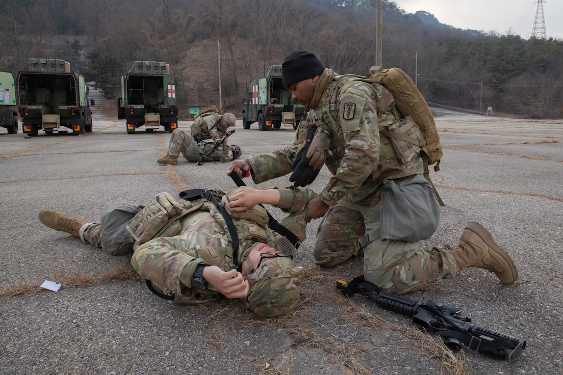 U.S. Army Sgt. Jerquel Jefferson applies a tourniquet to Pfc. Yujun Xia during a combat casualty care exercise conducted by the 560th Medical Company (Ground Ambulance) at Camp Stanley, South Korea, on March 9, 2026. The Dragon Lift exercise evaluates combined medical capacity and interoperability to ensure effective casualty care across the Korean theater. (U.S. Army photo by Spc. Jakaiyah Rumedon.)