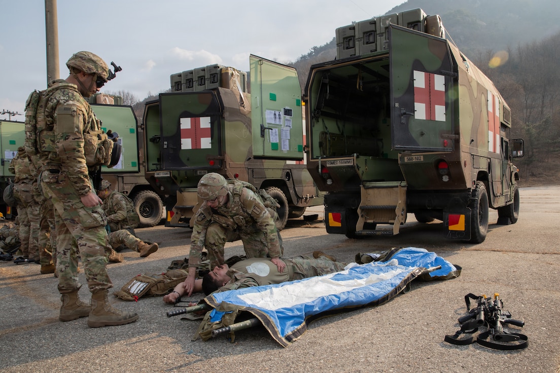 U.S. Army Staff Sgt. Benjamin Halliburton begins medical care for Spc. Dylan Breceda during a combat casualty care exercise conducted by the 560th Medical Company (Ground Ambulance) at Camp Stanley, South Korea, on March 9, 2026. The Dragon Lift exercise evaluates combined medical capacity and interoperability to ensure effective casualty care across the Korean theater. (U.S. Army photo by Spc. Jakaiyah Rumedon.)