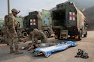 U.S. Army Staff Sgt. Benjamin Halliburton begins medical care for Spc. Dylan Breceda during a combat casualty care exercise conducted by the 560th Medical Company (Ground Ambulance) at Camp Stanley, South Korea, on March 9, 2026. The Dragon Lift exercise evaluates combined medical capacity and interoperability to ensure effective casualty care across the Korean theater. (U.S. Army photo by Spc. Jakaiyah Rumedon.)