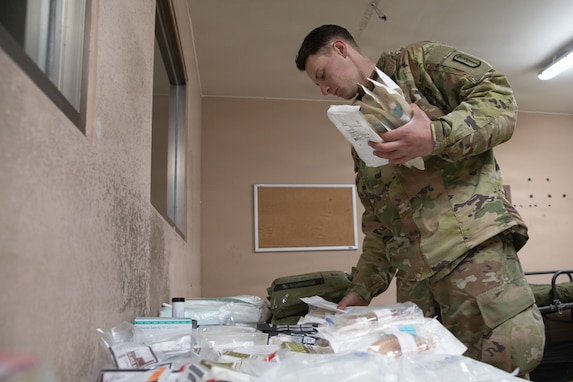 U.S. Army Spc. Justin Crabtree from the 629th Medical Company Area Support arranges medical supplies during Dragon Lift at Camp Stanley, South Korea, on March 9, 2026. The exercise evaluates combined medical capacity and interoperability to ensure effective casualty care across the Korean theater.