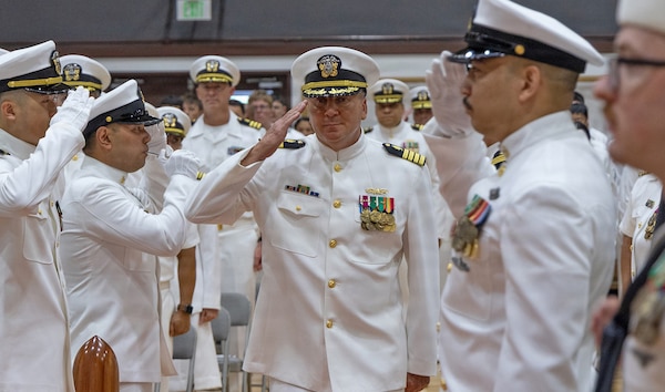 YOKOSUKA, Japan (July 23, 2026) — Capt. Joshua A. Miller passes through sideboys as he arrives for the U.S. Navy Medicine Readiness and Training Command (USNMRTC) Yokosuka change of command ceremony at Commander, Fleet Activities Yokosuka's C2 Auditorium. Miller relieved Capt. Torrin W. Velazquez as commanding officer of USNMRTC Yokosuka and director of U.S. Naval Hospital (USNH) Yokosuka during the ceremony. USNH Yokosuka delivers patient- and family-centered healthcare while developing and delivering trained, ready medical forces in support of U.S. Indo-Pacific Command. (U.S. Navy photo by Daniel Taylor/USNH Yokosuka Public Affairs)