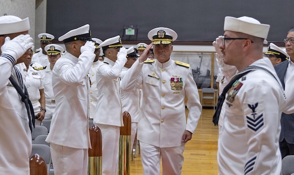 YOKOSUKA, Japan (July 23, 2026) — Rear Adm. Kevin J. Brown, commander, Naval Medical Forces Pacific; director, Defense Health Network Pacific Rim; and chief of the Navy Medical Corps, passes through sideboys before presiding over the U.S. Navy Medicine Readiness and Training Command Yokosuka change of command ceremony at Commander, Fleet Activities Yokosuka's C2 Auditorium. Brown officiated the transfer of command from Capt. Torrin W. Velazquez to Capt. Joshua A. Miller. USNMRTC Yokosuka delivers patient- and family-centered healthcare while developing and delivering trained, ready medical forces in support of U.S. Indo-Pacific Command. (U.S. Navy photo by Daniel Taylor/USNH Yokosuka Public Affairs)