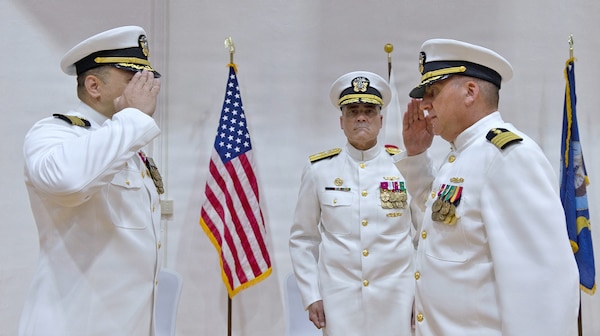 YOKOSUKA, Japan (July 23, 2026) — Capt. Joshua A. Miller (right) assumes command of U.S. Navy Medicine Readiness and Training Command Yokosuka from Capt. Torrin W. Velazquez (left) during a change of command ceremony at Commander, Fleet Activities Yokosuka's C2 Auditorium. Rear Adm. Kevin J. Brown, commander, Naval Medical Forces Pacific; director, Defense Health Network Pacific Rim; and chief of the Navy Medical Corps, presided over the ceremony. USNMRTC Yokosuka delivers patient- and family-centered healthcare while developing and delivering trained, ready medical forces in support of U.S. Indo-Pacific Command. (U.S. Navy photo by Daniel Taylor/USNH Yokosuka Public Affairs)