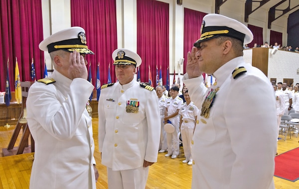 YOKOSUKA, Japan (July 23, 2026) — Capt. Torrin W. Velazquez and Capt. Joshua A. Miller exchange salutes with Rear Adm. Kevin J. Brown, commander, Naval Medical Forces Pacific; director, Defense Health Network Pacific Rim; and chief of the Navy Medical Corps, during the U.S. Navy Medicine Readiness and Training Command Yokosuka change of command ceremony at Commander, Fleet Activities Yokosuka's C2 Auditorium. The exchange marked the formal transition of command under the direction of Rear Adm. Kevin J. Brown. USNMRTC Yokosuka delivers patient- and family-centered healthcare while developing and delivering trained, ready medical forces in support of U.S. Indo-Pacific Command. (U.S. Navy photo by Daniel Taylor/USNH Yokosuka Public Affairs)