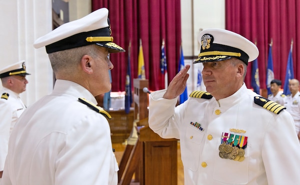 YOKOSUKA, Japan (July 23, 2026) — Capt. Joshua A. Miller salutes Rear Adm. Kevin J. Brown, commander, Naval Medical Forces Pacific; director, Defense Health Network Pacific Rim; and chief of the Navy Medical Corps, during the U.S. Navy Medicine Readiness and Training Command (USNMRTC) Yokosuka change of command ceremony at Commander, Fleet Activities Yokosuka's C2 Auditorium.. Miller assumed command from Capt. Torrin W. Velazquez during the ceremony. USNMRTC Yokosuka delivers patient- and family-centered healthcare while developing and delivering trained, ready medical forces in support of U.S. Indo-Pacific Command. (U.S. Navy photo by Daniel Taylor/USNH Yokosuka Public Affairs)
