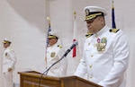 YOKOSUKA, Japan (July 23, 2026) — Capt. Torrin W. Velazquez reads his official orders during the U.S. Navy Medicine Readiness and Training Command Yokosuka change of command ceremony at Commander, Fleet Activities Yokosuka's C2 Auditorium. The reading of orders formally transferred command from Capt. Torrin W. Velazquez to Capt. Joshua A. Miller. USNMRTC Yokosuka delivers patient- and family-centered healthcare while developing and delivering trained, ready medical forces in support of U.S. Indo-Pacific Command. (U.S. Navy photo by Daniel Taylor/USNH Yokosuka Public Affairs)
