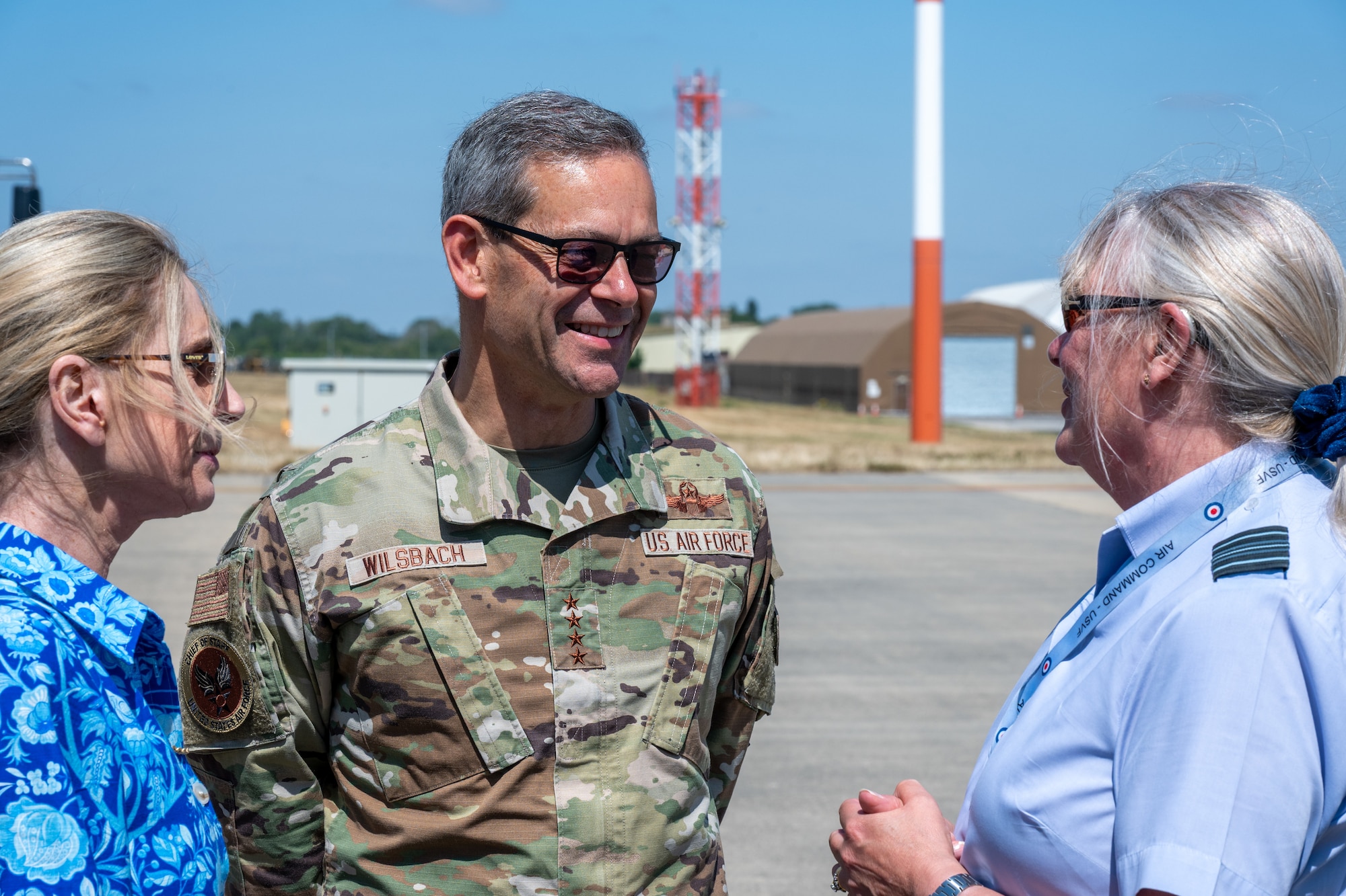Chief of Staff of the Air Force Gen. Ken Wilsbach and his wife, Mrs. Cindy Wilsbach, speak with Royal Air Force Sqn. Ldr. Jayne M. Robertson, RAF Fairford commander