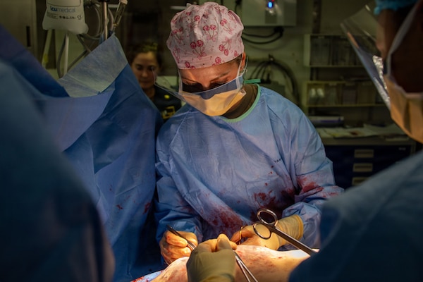 U.S. Army Capt. Danielle Patrick, assigned to Surgical Augmentation Detachment 105, performs a mock surgery during a mass casualty drill aboard Wasp-class amphibious assault ship USS Essex (LHD 2), July 10, 2026, during Exercise Rim of the Pacific (RIMPAC) 2026. Thirty nations, 30 ships, 5 submarines, 15 national land forces, more than 190 aircraft and more than 30,000 personnel are participating in RIMPAC in and around the Hawaiian Islands, June 24 to July 31. The world's largest international maritime exercise, RIMPAC provides a unique training opportunity while fostering and sustaining cooperative relationships among participants critical to ensuring the safety of sea lanes and security on the world's oceans. RIMPAC 2026 is the 30th exercise in the series that began in 1971. (U.S. Navy photo by Mass Communication Specialist Seaman Zachary Warr)