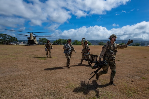 Canadian servicemembers, assigned to the Canadian Medical Emergency Response Team, depart a U.S. Army CH-47D Chinook, assigned to 25th Combat Aviation Brigade, during a mass casualty drill during Rim of the Pacific (RIMPAC) 2026, July 10, 2026. Thirty nations, 30 ships, 5 submarines, 15 national land forces, more than 190 aircraft and more than 30,000 personnel are participating in RIMPAC in and around the Hawaiian Islands, June 24 to July 31. The world's largest international maritime exercise, RIMPAC provides a unique training opportunity while fostering and sustaining cooperative relationships among participants critical to ensuring the safety of sea lanes and security on the world's oceans. RIMPAC 2026 is the 30th exercise in the series that began in 1971. (U.S. Navy photo by Mass Communication Specialist 1st Class Russell Rhodes Jr.)