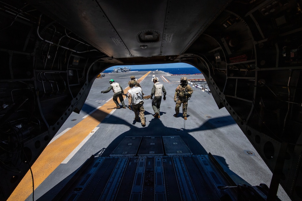 Canadian servicemembers, assigned to the Canadian Medical Emergency Response Team, carry a simulated combat casualty off of a U.S. Army CH-47D Chinook, assigned to 25th Combat Aviation Brigade, onto Wasp-class amphibious assault ship USS Essex (LHD 2) during a mass casualty drill for Exercise Rim of the Pacific (RIMPAC) 2026, July 10, 2026. Thirty nations, 30 ships, 5 submarines, 15 national land forces, more than 190 aircraft and more than 30,000 personnel are participating in RIMPAC in and around the Hawaiian Islands, June 24 to July 31. The world's largest international maritime exercise, RIMPAC provides a unique training opportunity while fostering and sustaining cooperative relationships among participants critical to ensuring the safety of sea lanes and security on the world's oceans. RIMPAC 2026 is the 30th exercise in the series that began in 1971. (U.S. Navy photo by Mass Communication Specialist 1st Class Russell Rhodes Jr.)