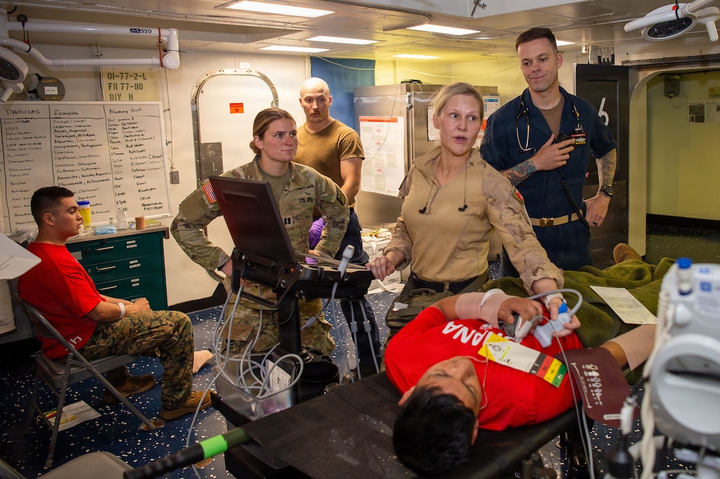 U.S. Army Capt. Katherine Boyd, assigned to the 105th Surgical Augmentation Detachment, Canadian Armed Forces Lieutenant-Colonel Alison Kabaroff, assigned to the Canadian Medical Emergency Response Team, and U.S. Navy Senior Chief Hospital Corpsman William Myers, assigned to Wasp-class amphibious assault ship USS Essex (LHD 2), oversee the diagnosing of a simulated injured patient during a mass casualty drill for Exercise Rim of the Pacific (RIMPAC) 2026, July 10, 2026. Thirty nations, 30 ships, 5 submarines, 15 national land forces, more than 190 aircraft and more than 30,000 personnel are participating in RIMPAC in and around the Hawaiian Islands, June 24 to July 31. The world's largest international maritime exercise, RIMPAC provides a unique training opportunity while fostering and sustaining cooperative relationships among participants critical to ensuring the safety of sea lanes and security on the world's oceans. RIMPAC 2026 is the 30th exercise in the series that began in 1971. (U.S. Navy photo by Mass Communication Specialist Seaman Apprentice Samuel B. Park)