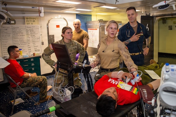 U.S. Army Capt. Katherine Boyd, assigned to the 105th Surgical Augmentation Detachment, Canadian Armed Forces Lieutenant-Colonel Alison Kabaroff, assigned to the Canadian Medical Emergency Response Team, and U.S. Navy Senior Chief Hospital Corpsman William Myers, assigned to Wasp-class amphibious assault ship USS Essex (LHD 2), oversee the diagnosing of a simulated injured patient during a mass casualty drill for Exercise Rim of the Pacific (RIMPAC) 2026, July 10, 2026. Thirty nations, 30 ships, 5 submarines, 15 national land forces, more than 190 aircraft and more than 30,000 personnel are participating in RIMPAC in and around the Hawaiian Islands, June 24 to July 31. The world's largest international maritime exercise, RIMPAC provides a unique training opportunity while fostering and sustaining cooperative relationships among participants critical to ensuring the safety of sea lanes and security on the world's oceans. RIMPAC 2026 is the 30th exercise in the series that began in 1971. (U.S. Navy photo by Mass Communication Specialist Seaman Apprentice Samuel B. Park)