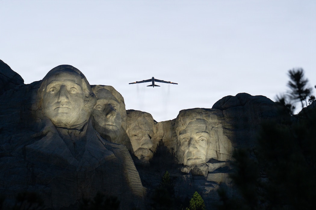 A B-52 Stratofortress assigned to the 5th Bomb Wing flies over Mount Rushmore National Memorial during a Freedom 250 celebration, July 3, 2026. The B-52 remains a key component of America's long-range strategic deterrence capability. (U.S. Air National Guard photo by 2nd Lt. Jorrie Hart)