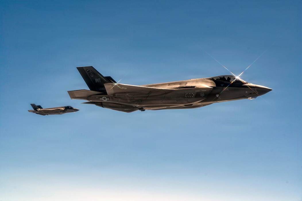 F-35A Lightning IIs assigned to the 115th Fighter Wing, Wisconsin Air National Guard, fly in formation while awaiting aerial refueling from a KC-46A Pegasus assigned to the 32nd Air Refueling Squadron over Wisconsin, June 25, 2026. The mission supported Operation Iron Orchid, the 115th Fighter Wing's largest exercise in 23 years. (U.S. Air Force photo by Airman 1st Class Francine D. Martin)