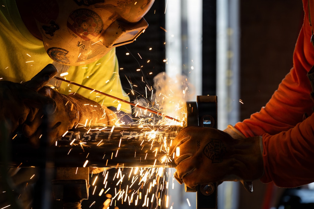 A contractor welds a 6-inch Schedule 40 HVAC pipe during an infrastructure improvement project, July 14, 2026, at Whiteman Air Force Base, Mo. The project supports quality-of-life improvements for Airmen and their families. (U.S. Air Force photo by Senior Airman Matthew S. Domingos)