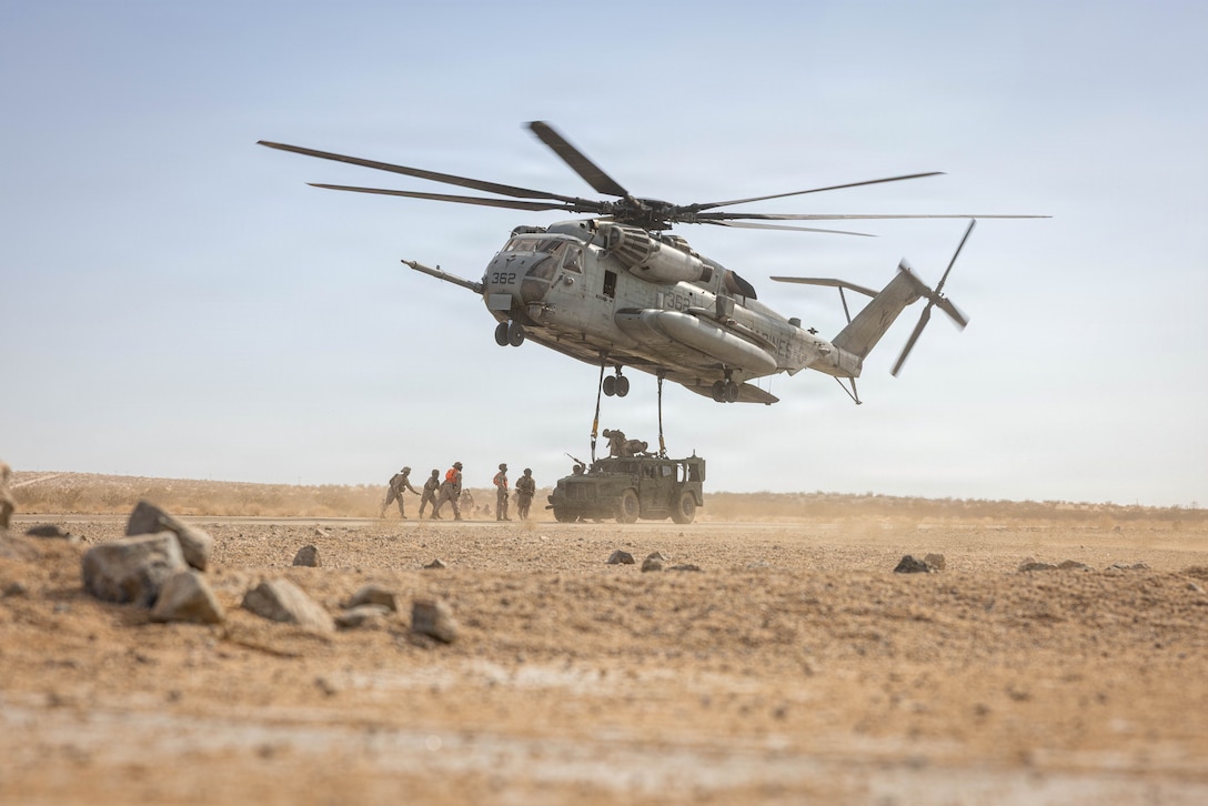 U.S. Marines with Landing Support Platoon, Combat Logistics Battalion 2, attached to 2nd Regimental Combat Team, attach a Joint Light Tactical Vehicle to a Ch-53 Super Stallion during a heavy lift training at Service Level Training Exercise 4-26 on Marine Corps Air Ground Combat Center, Twentynine Palms, California, July 21, 2026. SLTE 4-26 is designed to be a challenging, realistic training environment that produces combat-ready forces capable of operating as an integrated Marine Air Ground Task Force across all domains of military operations. (U.S. Marine Corps photo by Sgt. Alexis French)