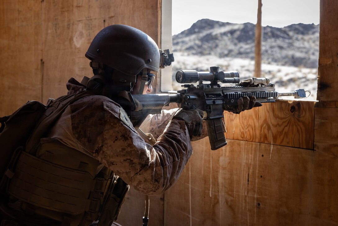 A U.S. Marine with Easy Company, 2nd Battalion, 2nd Marine Regiment, 2nd Marine Division, posts security during counter small-unmanned aircraft systems urban training at Range 200 during Service Level Training Exercise 4-26 on Marine Corps Air Ground Combat Center, Twentynine Palms, California, July 22, 2026. With the debut of C-sUAS lanes at the Combat Center, Marines recognize and respond to unmanned aerial threats by employing emerging tactics, techniques, procedures, and maintaining a C-sUAS mindset in every operation, all while preserving the fundamentals that make rifle squads survivable and lethal. SLTE 4-26 is a premier training event that ensures the Marine Corps remains a highly lethal, adaptable force capable of dominating the future multi-domain fight. (U.S. Marine Corps photo by Sgt. Alexis French)