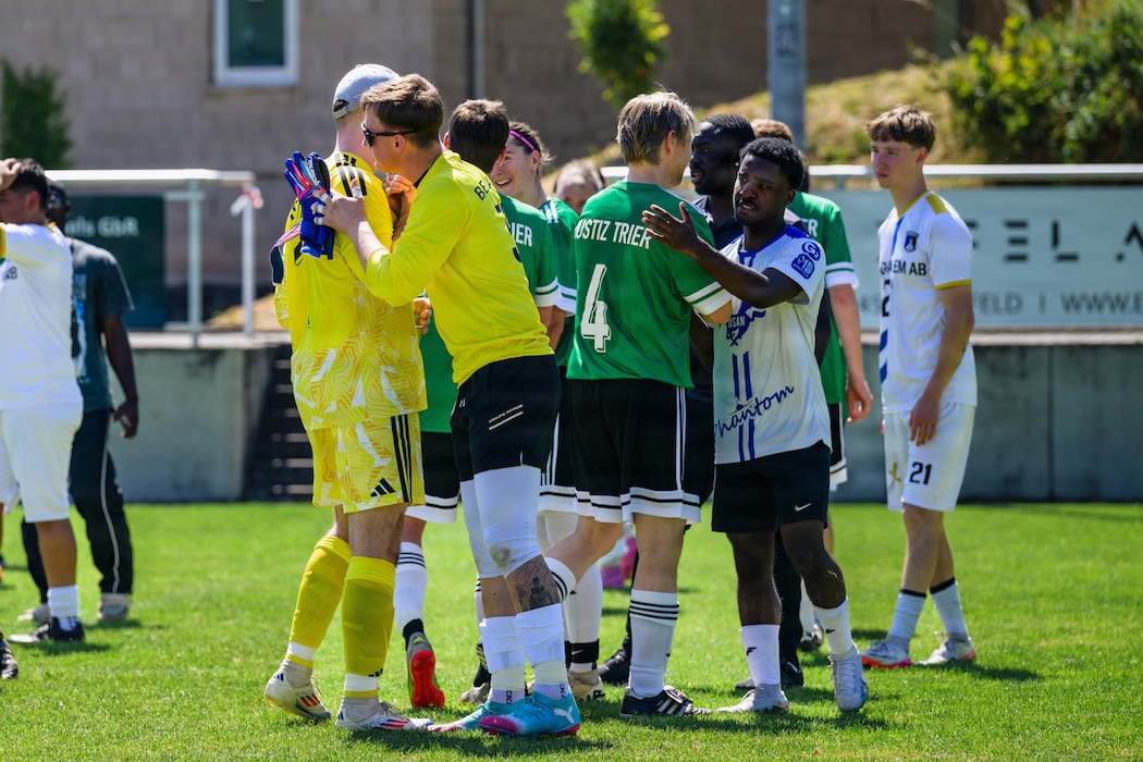 Soccer players shake hands.