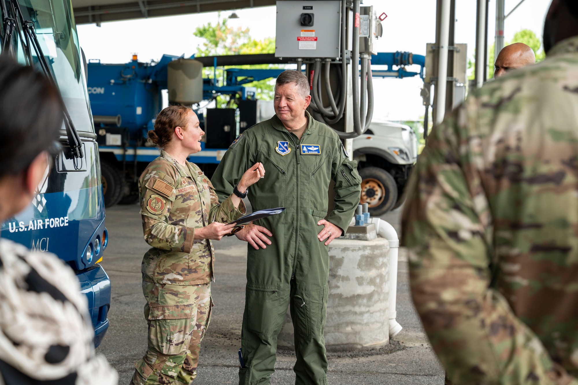 U.S. Air Force Maj. Gen. stands in front of U.S. Air Force bus speaking to a Lt. Col.