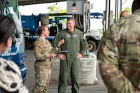 U.S. Air Force Maj. Gen. stands in front of U.S. Air Force bus speaking to a Lt. Col.
