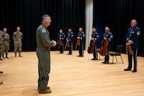 U.S. Air Force Maj. Gen. stands in front of The Band musicians